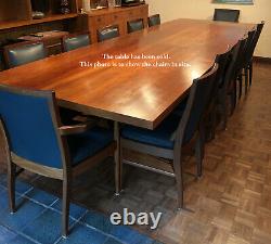 2 carver and 10 side dining chairs upholstered in navy faux leather