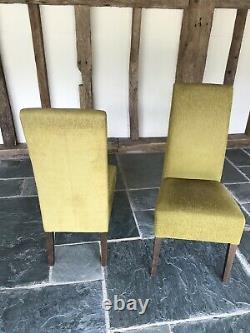 A set of 10 high back upholstered dining chairs used in overall good condition