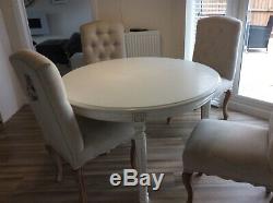 Circular extendable dining table and 4 upholstered chairs