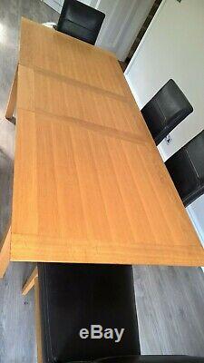 Extendable oak dining table and 6 leather upholstered oak chairs
