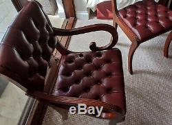 Mahogany Oval Dining Table and 6 Burgundy Upholstered Hide Chairs (2 carvers)