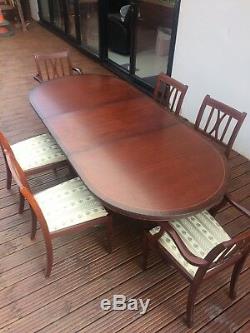 Mahogany extending family dining table with 6 matching upholstered chairs