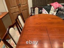 Nathan extending dining table and eight upholstered chairs