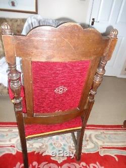 Pair of carved Oak elbow upholstered dining chairs with castors