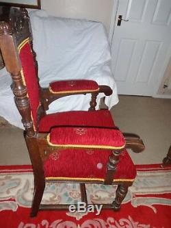 Pair of carved Oak elbow upholstered dining chairs with castors