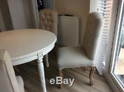 Round extendable dining table with 4 upholstered chairs