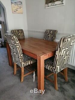 Solid oak dining table and 4 upholstered chairs