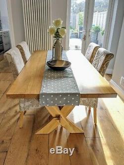 Solid oak dining table with 6 upholstered chairs (2 chairs not pictured)