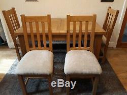 Solid oak extending dining table and 4 upholstered chairs
