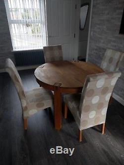 Solid oak round dining table and 4 upholstered dining chairs