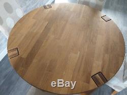 Solid oak round dining table and 4 upholstered dining chairs