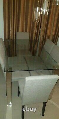 Used glass dining table and upholstered chairs